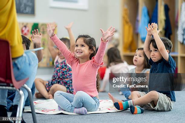 singing at circle time - preschool age stock pictures, royalty-free photos & images