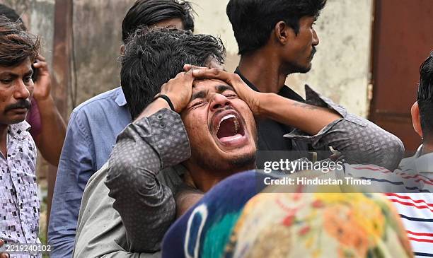Family members of 15 year old Air India Plane crash victim Akash Pathani mourn outside Postmorter Centre in Civil Hospital on June 13, 2025 in...