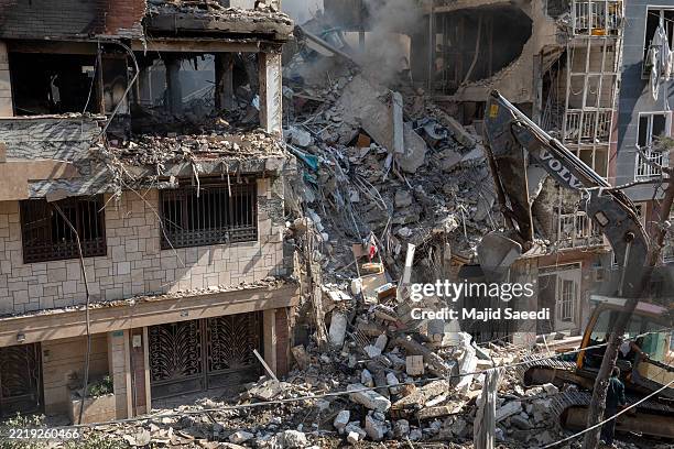 An excavator removes debris from a residential building that was destroyed in today's attack by Israel in Tehran, on June 13, 2025 in Tehran, Iran....