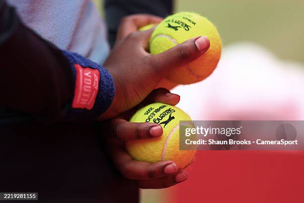 Ball girl holds Wimbledon 2025 tennis balls at The Queen's Club on June 13, 2025 in London, England.