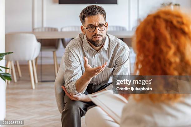 professional counseling session in a modern cozy office environment - showing empathy stock pictures, royalty-free photos & images