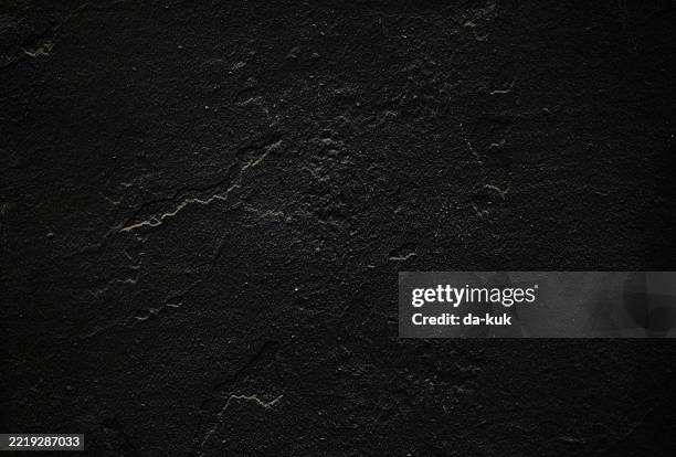 a dark cracked textured wall with a rough unique surface pattern - crevice stock pictures, royalty-free photos & images