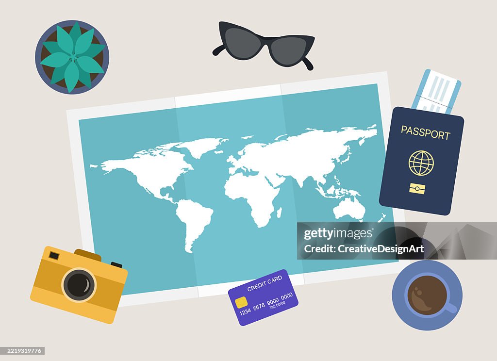 Travel Planning Concept. High Angle View Of Table With World Map, Passport, Airplane Ticket, Credit Card, Camera And Sunglasses
