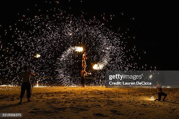 Fire spinners perform at the Khlong Prao Beach Resort on June 07, 2025 in Koh Chang, Thailand. Koh Chang, which means “Elephant Island” in Thai, was...