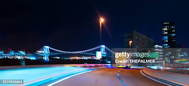 curving toward rainbow bridge at night - neon car shape stock pictures, royalty-free photos & images