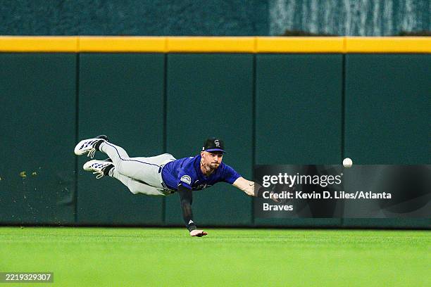 Brenton Doyle of the Colorado Rockies dives for a ball during the fifth inning against the Atlanta Braves at Truist Park on June 13, 2025 in Atlanta,...