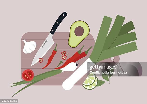 a sharp knife and various fruits and vegetables on a wooden cutting board - cutting food stock illustrations