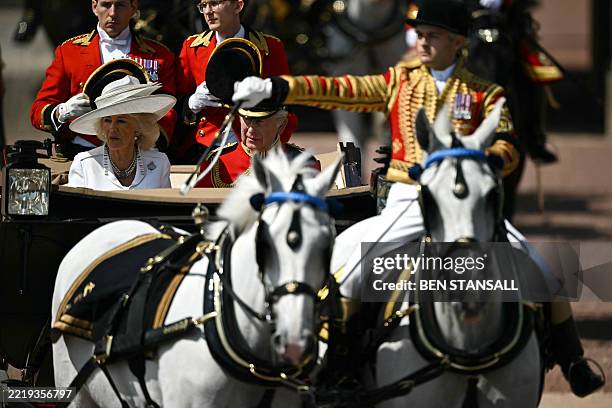 Britain's King Charles III and Britain's Queen Camilla make their way from Buckingham Palace to Horse Guards Parade for the King's Birthday Parade,...