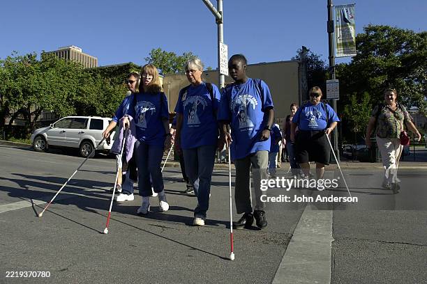 View of blind & visually impaired participants, most with guide canes, as they march on Congress Avenue for White Cane Safety Day, Austin, Texas,...