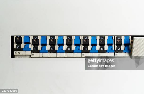 row of circuit breakers showing overload protection in electrical panel - fuse box stock pictures, royalty-free photos & images