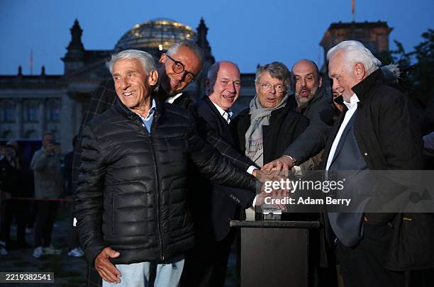 Berlin Mayor Kai Wegner presses a button to launch a projection of the "Wrapped Reichstag" by artists Christo and Jeanne-Claude, to be displayed on...