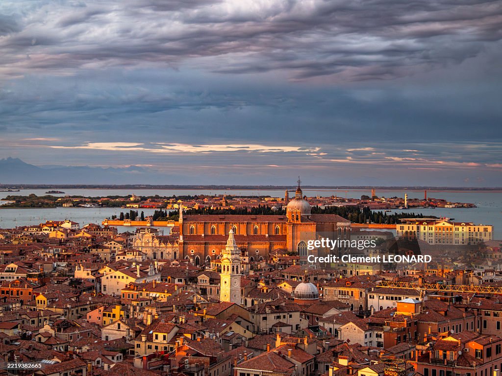 Aerial view of the Castello district and the Venice lagoon at sunset during the golden hour, with the Basilica dei Santi Giovanni e Paolo Church, the San Michele island and Murano, UNESCO World Heritage Site - Veneto - Italy.