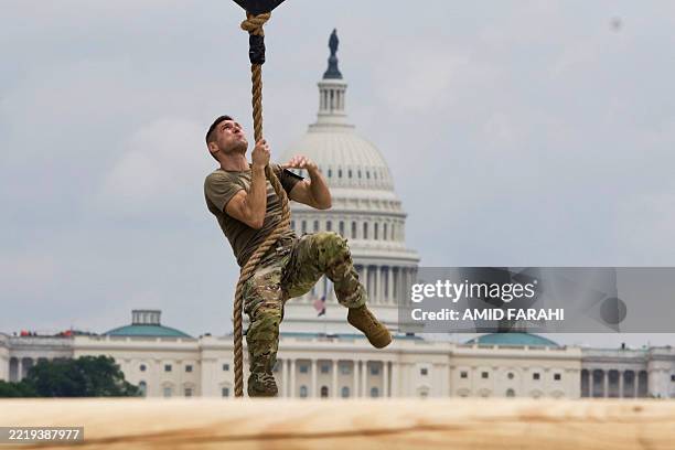 Soldier Rope US soldier climbs a rope as he participates in a fitness competition ...