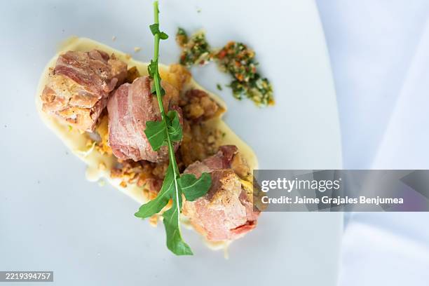 delicious chicken ballotines wrapped in bacon with creamy sauce and arugula - main course stock pictures, royalty-free photos & images