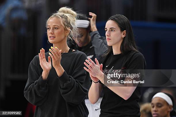 Sophie Cunningham and Caitlin Clark of the Indiana Fever cheer from the bench against the Chicago Sky at the United Center on June 07, 2025 in...
