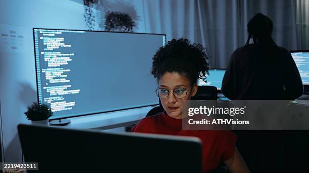 focused hispanic female programmer working on code at computer, modern cybersecurity and technology concept - web designer stock pictures, royalty-free photos & images