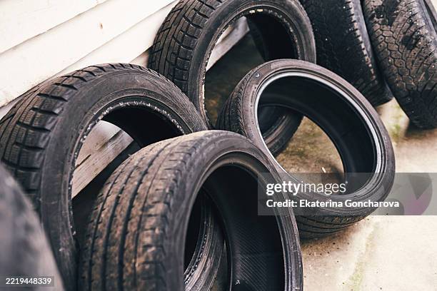 stacked vehicle tires arranged neatly against a white background - old tyre stock pictures, royalty-free photos & images