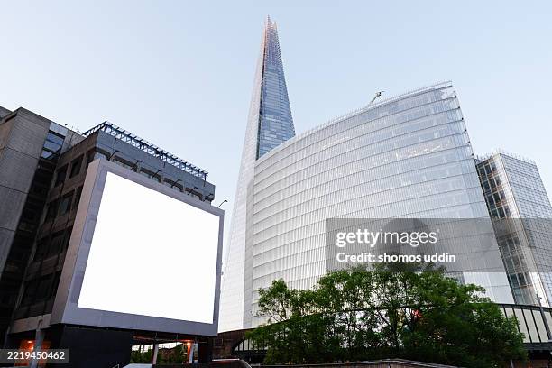 digital billboard against modern office buildings - electronic billboard stock pictures, royalty-free photos & images