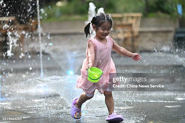 Girl plays in a fountain to cool off on June 10, 2025 in Chengdu, Sichuan Province of China. The Chengdu Meteorological Observatory issued an orange...