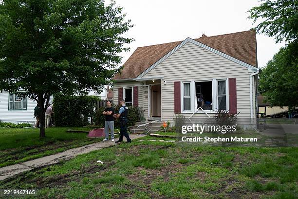 Vance Boelter's roommate, who declined to give his name, speaks with a Minneapolis police officer outside his home on June 14, 2025 in Minneapolis,...