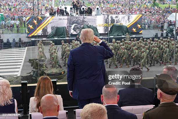 President Donald Trump stands and salutes troops during the celebration of the Army's 250th birthday on the National Mall on June 14, 2025 in...