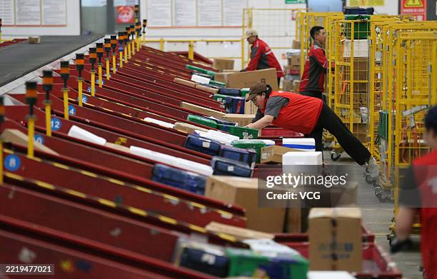Employees work on the intelligent sorting line at a logistics center ahead of 618 Shopping Festival on June 10, 2025 in Haidong, Qinghai Province of...
