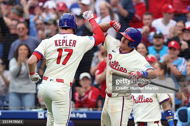 Max Kepler of the Philadelphia Phillies celebrates with teammate J.T. Realmuto after hitting a solo home run in the eighth inning during a game...