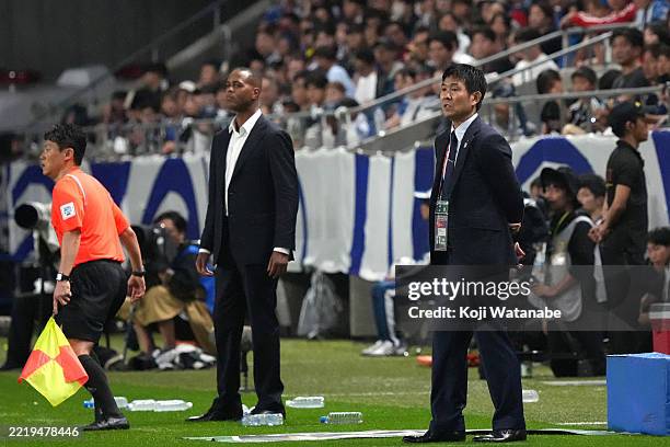 Head coach Hajime Moriyasu of Japan and Head coach Patrick Kluivert of Indonesia look on during the FIFA World Cup Asian Third Qualifier Group C...