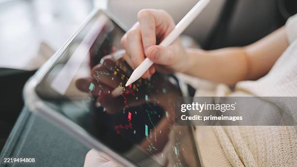 scene of a woman using smartphone with stylus to evaluate financial data, representing digital finance, fintech tools, and market volatility monitoring in a mobile-first investment world. 2026 - financial technology stock pictures, royalty-free photos & images
