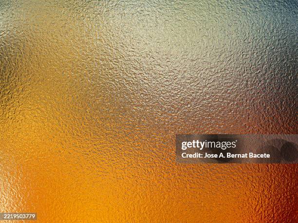 abstract background, gold metal sheet with a smooth, rough texture. - solid gold stock pictures, royalty-free photos & images