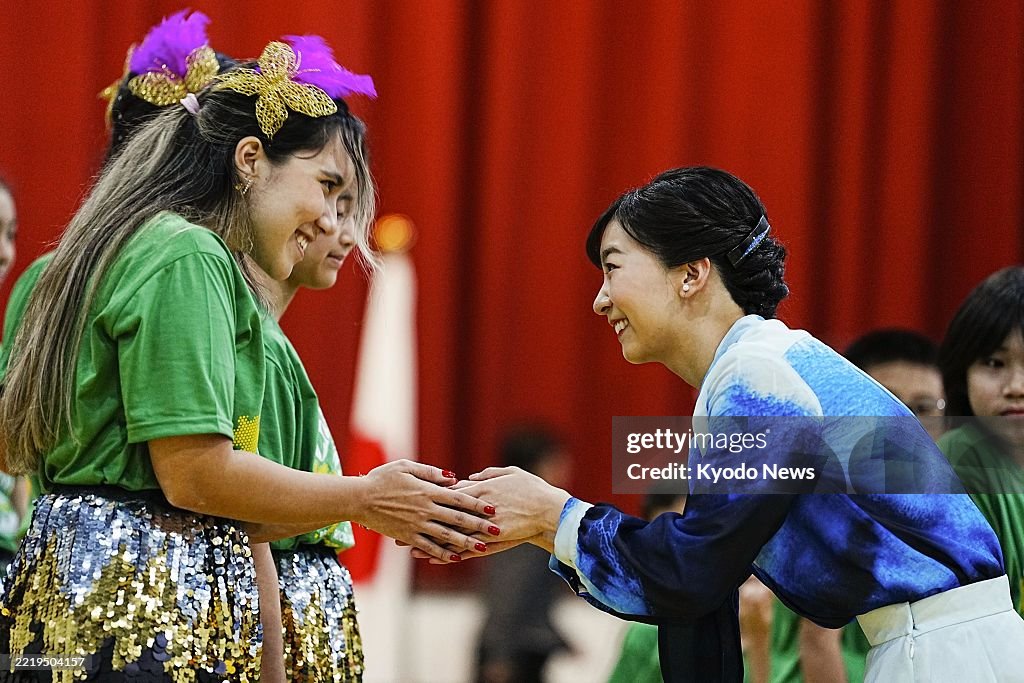Kako Rajar Japanese Princess Kako holds a child's hands after she danced samba ...
