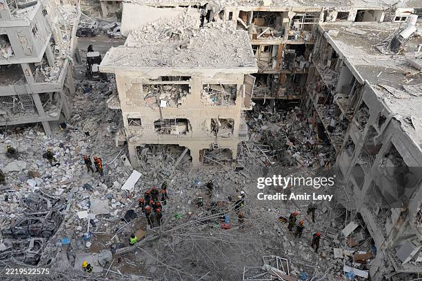 Emergency and rescue soldiers search for trapped people around heavily damaged buildings after an overnight missile strike from Iran on June 15, 2025...