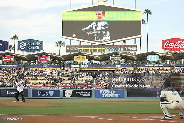 Gov. Denny Tamaki of Japan's Okinawa Prefecture throws the ceremonial first pitch ahead of a baseball game between the Los Angeles Dodgers and the...