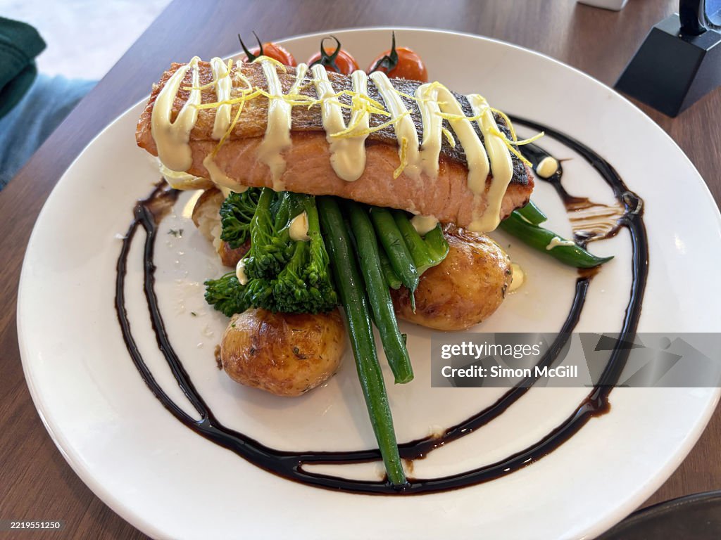 Crispy skin Atlantic salmon, blistered cherry tomato, twice cooked potato, broccoli, green beans, and lemon myrtle hollandaise sauce