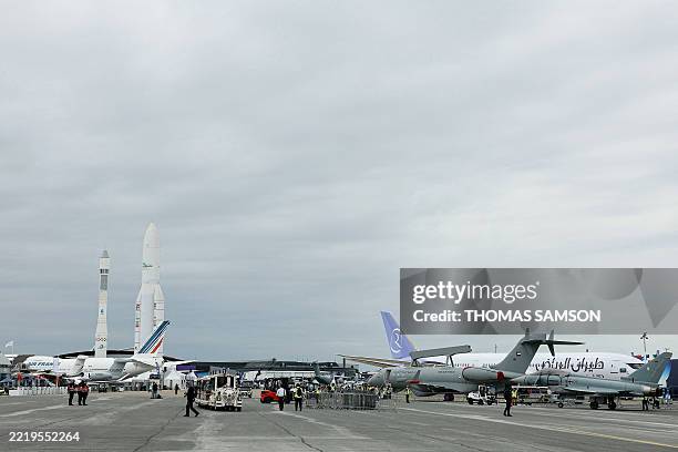 This general view shows aircrafts and Ariane 1 and Ariane 5 ECA space rockets displayed during the 55th edition of the International Paris Air Show...