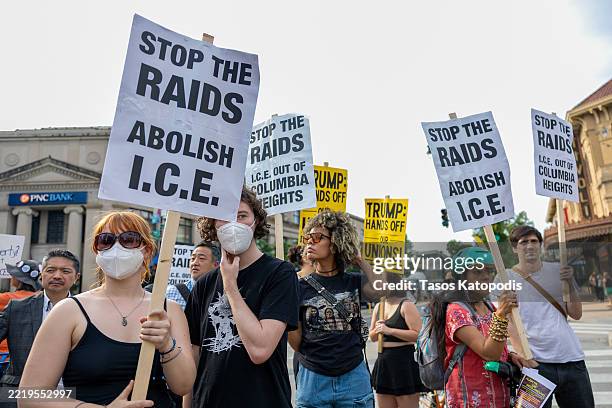 Protesters denounce the ongoing raids and deportations by U.S. Immigration and Customs Enforcement during a demonstration in Columbia Heights on June...