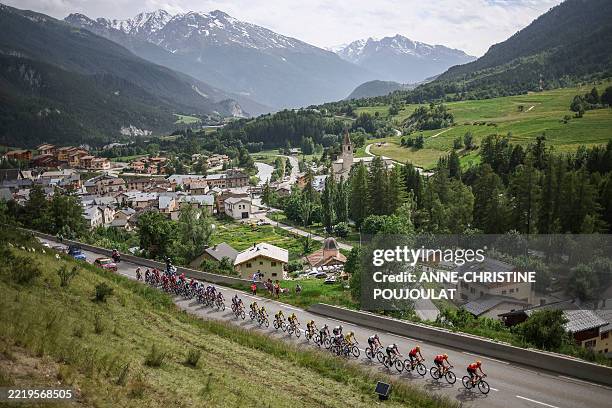 The pack of riders cycles past the town of Termignon during the 8th and final stage of the 77th edition of the Criterium du Dauphine cycling race 3...