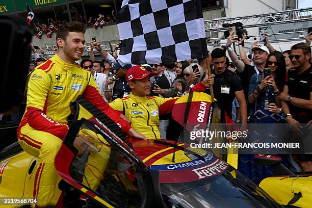 Corse's British driver Philip Hanson and AF Corse's Chinese driver Yifei Ye celebrate as AF Corse's Polish driver Robert Kubica wins in the 24 Hours...