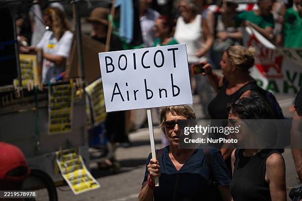 Protestor holds a banner that reads ''Boicot Airbnb'' during an anti-tourism demonstration in Barcelona, Catalunya, Spain, on June 15, 2025.