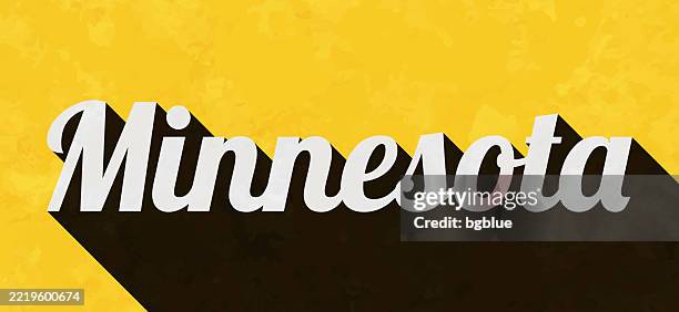 minnesota - text with long shadow on textured yellow background - minnesota flag stock illustrations