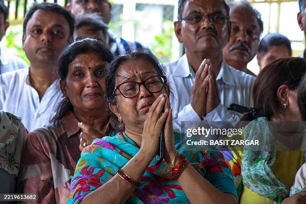Relatives grieve as they attend the funeral of Shubh Modi and his sister Shagun Modi, both victims of the Air India plane crash, at a crematorium in...