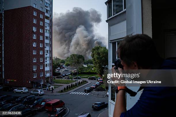 Man takes pictures of the smoke on June 10, 2025 in Kyiv, Ukraine. On the night of June 10, the Russian army attacked Kyiv with ballistic missiles...