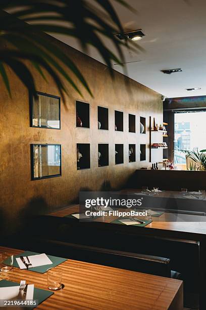 elegant restaurant interior with wooden tables and decorative wall - niche stock pictures, royalty-free photos & images