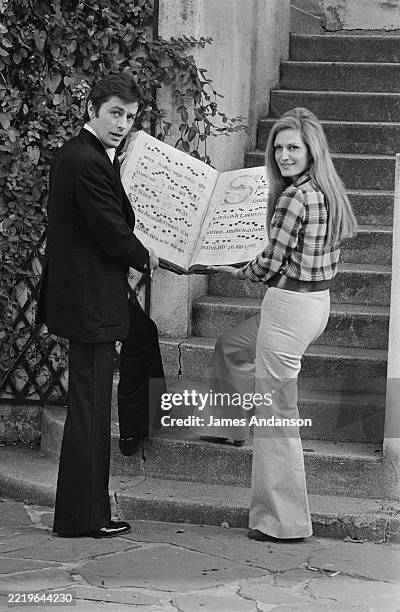 Egyptian-born singer Dalida with French actor Alain Delon at her home in Montmartre, November 1972.