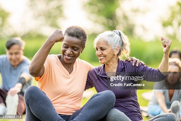 active senior friends exercising outdoors with joy and positivity - female friendship stock pictures, royalty-free photos & images