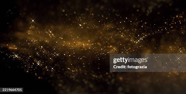 golden sparkle particles with twinkling star effect - fantaisie photos et images de collection