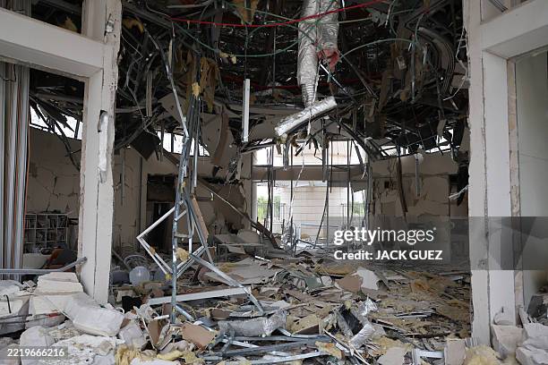 This photo shows a general view of a damaged building following a strike by an Iranian missile in the Israeli city of Petah Tikva, east of Tel Aviv,...