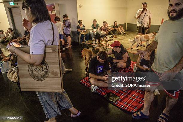 Israelis seen taking shelter in a public underground facility during an Iranian ballistic missile barrage. Israelis gather at public shelters during...