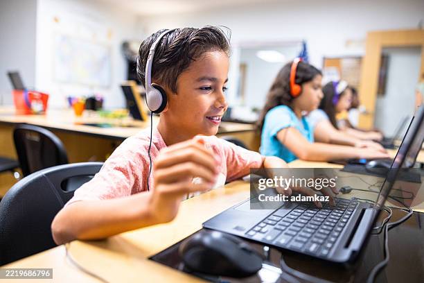 elementary students learning in the computer lab with their teacher - classroom laptop stock pictures, royalty-free photos & images