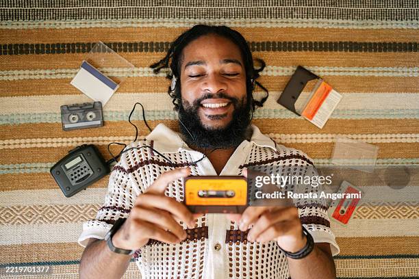 young man listening to cassette tapes with walkman - analog stock pictures, royalty-free photos & images
